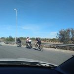 Hire car passing cyclists safely on a Spanish rural road.