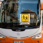 School bus in Spain displaying child transport signage.